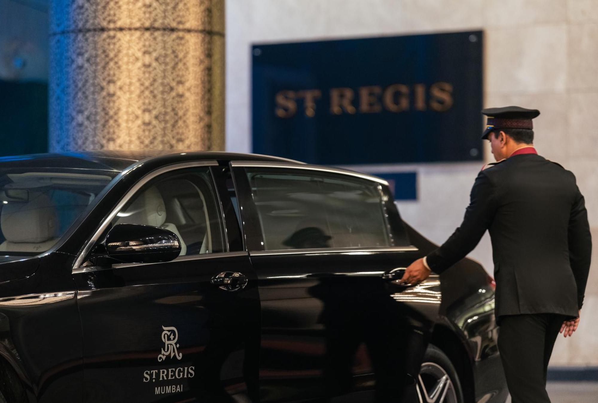 The St. Regis Mumbai Hotell Eksteriør bilde A chauffeur opening the door of a car
